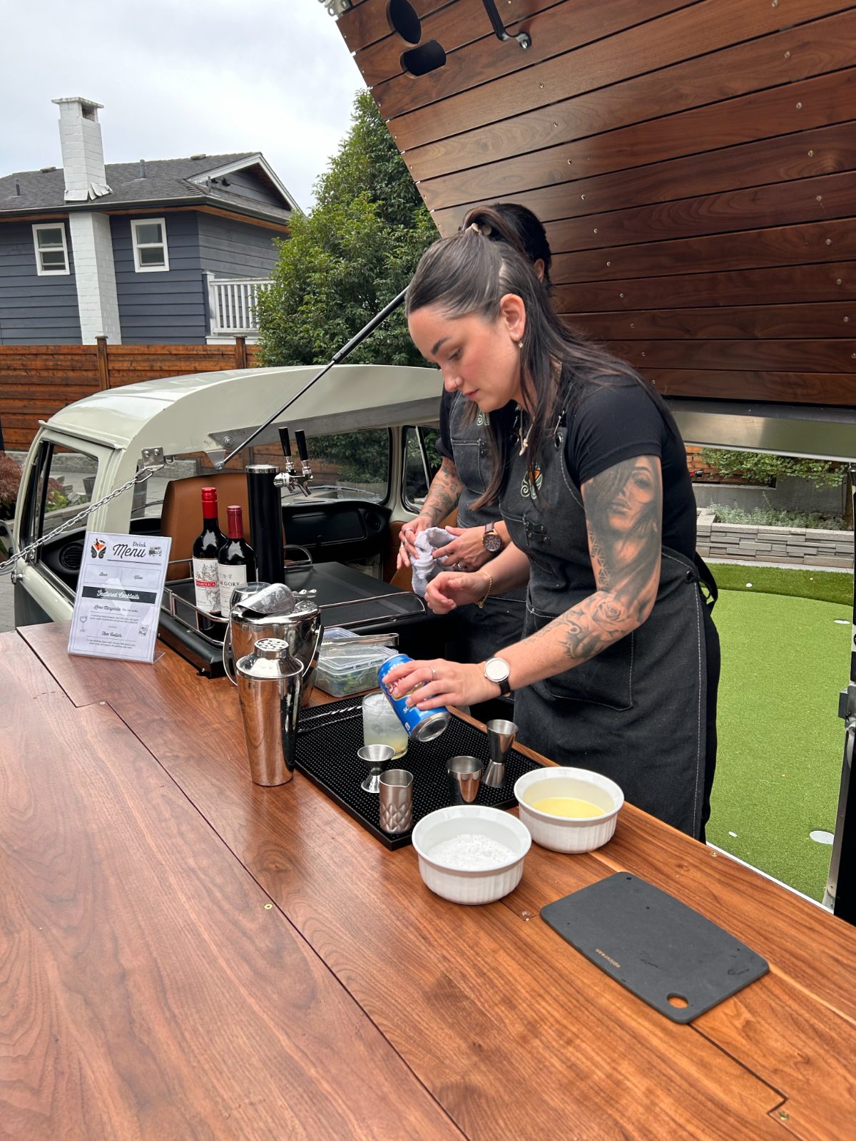 Bartender topping a cocktail with soda