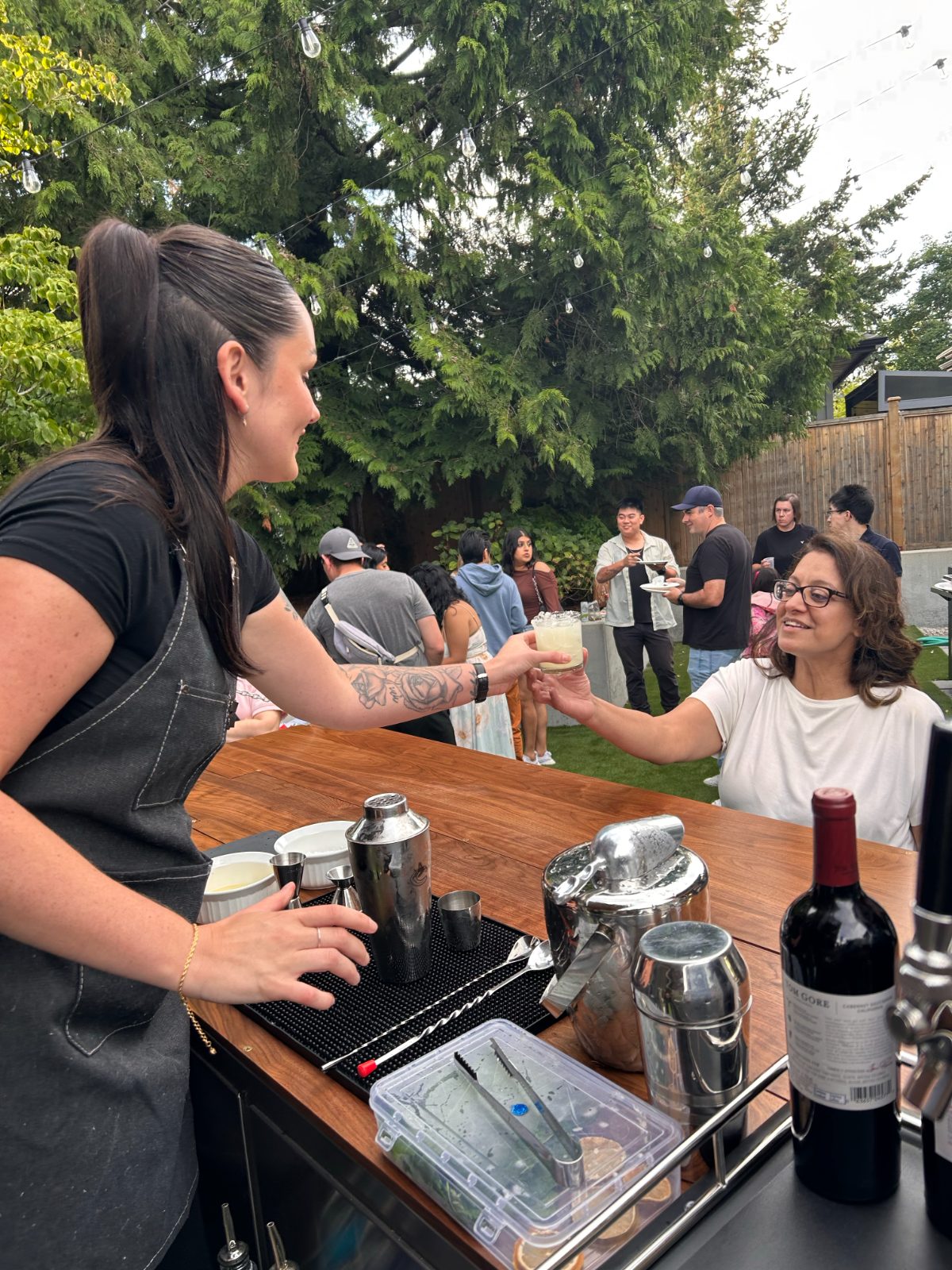Bartender handing a cocktail to a guest