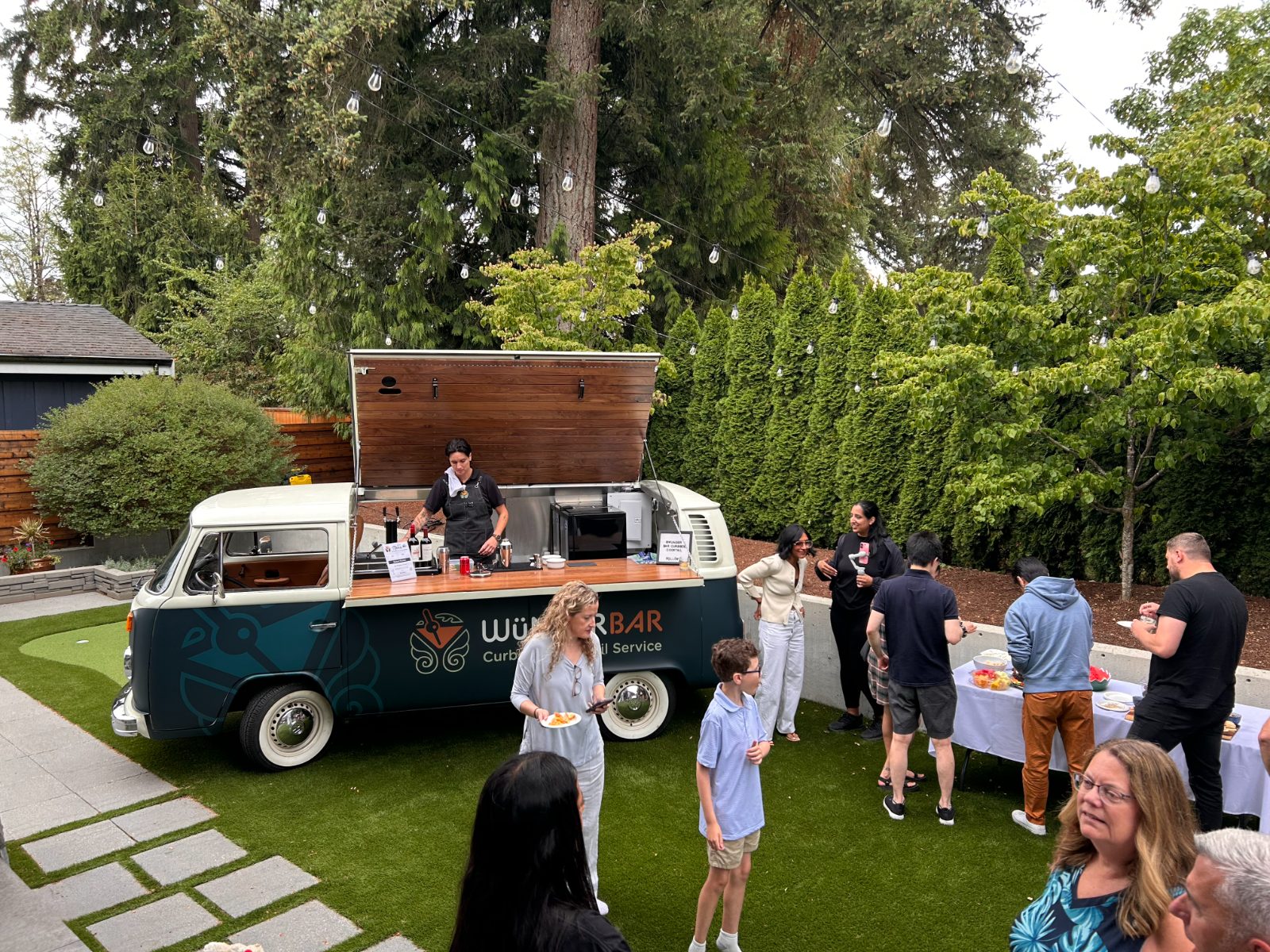 Backyard party with the bus serving drinks
